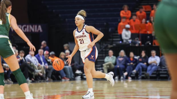 Kymora Johnson handles the ball during the Virginia women's basketball game against William & Mary at John Paul Jones Arena.